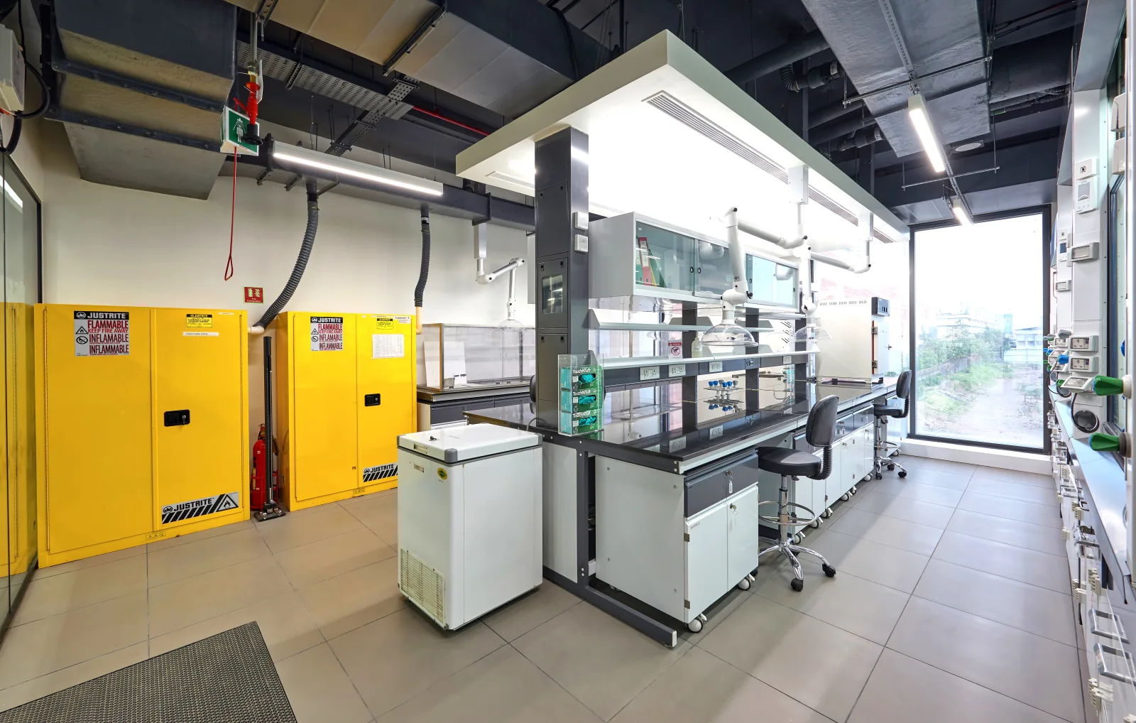 Chemistry laboratory with fume hood, snorkel extractors and flammable storage cabinets