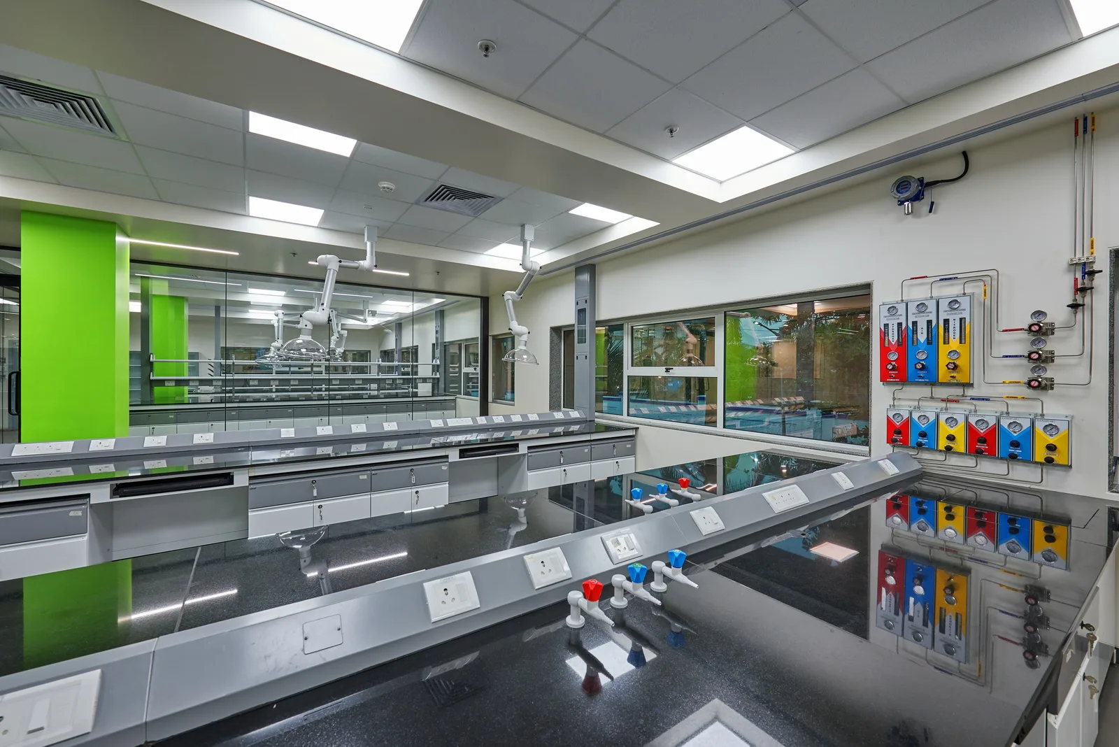 Research laboratory with fume hood and colour-coded gas manifold panels